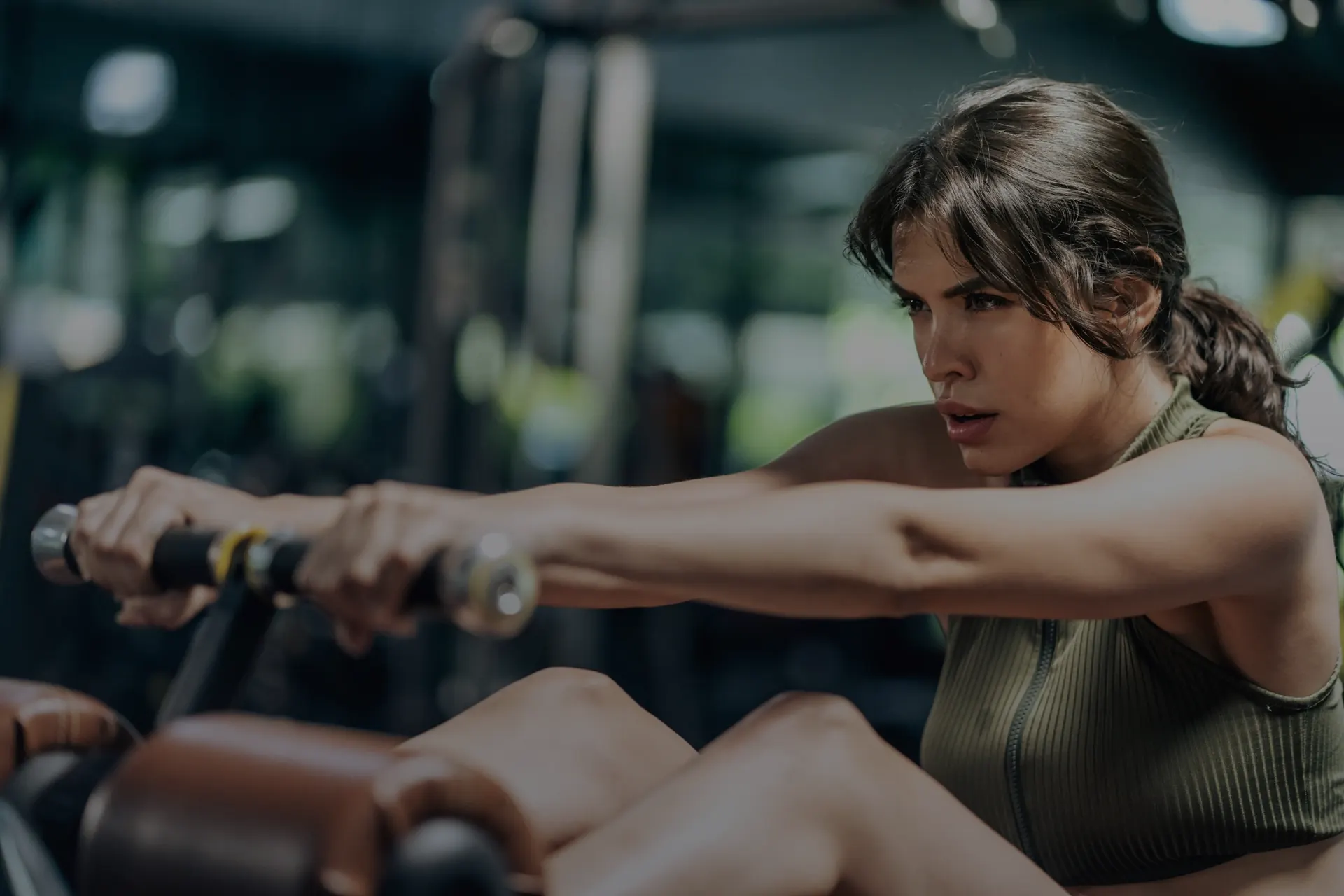 Woman training independently in a gym